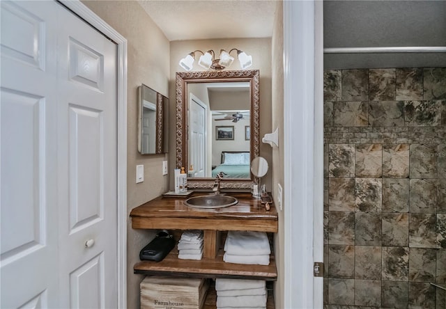 bathroom featuring ceiling fan and vanity