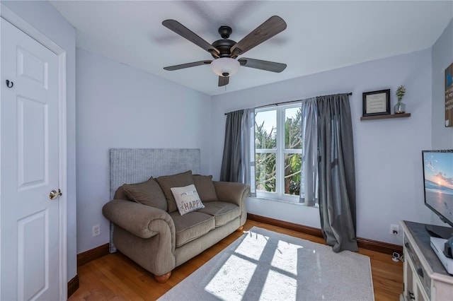 living room with ceiling fan and wood-type flooring