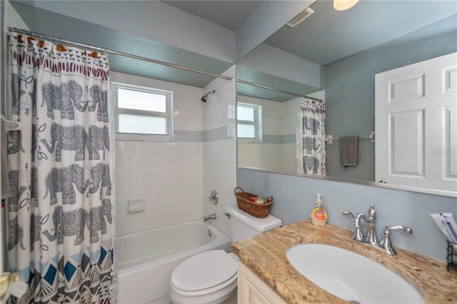 full bathroom with vanity, shower / bath combo, and toilet