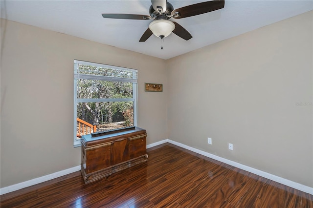 spare room with ceiling fan and dark hardwood / wood-style flooring