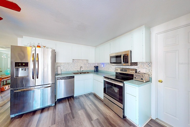 kitchen with sink, light hardwood / wood-style flooring, white cabinets, and appliances with stainless steel finishes