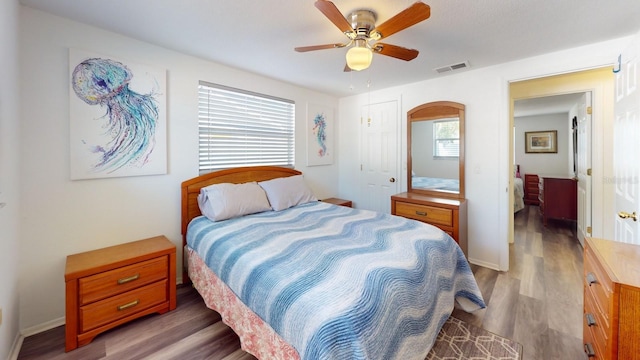 bedroom featuring dark hardwood / wood-style flooring and ceiling fan