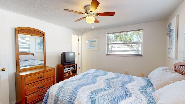 bedroom featuring ceiling fan and a textured ceiling