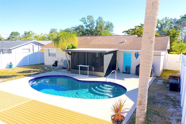 view of pool with a patio area and a sunroom