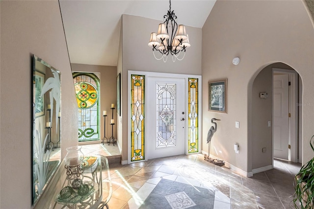 entryway with an inviting chandelier and high vaulted ceiling