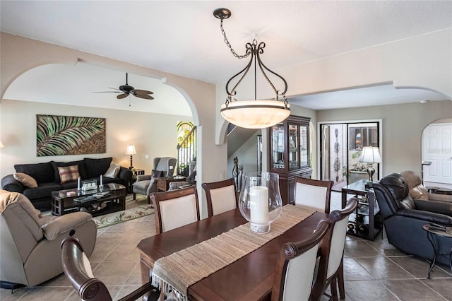 tiled dining space with ceiling fan