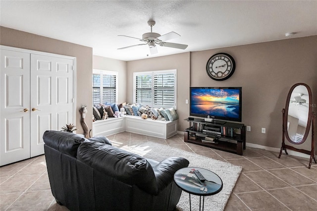 living room with tile patterned floors and ceiling fan