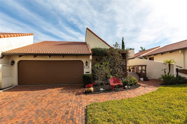 mediterranean / spanish house with a garage and a front yard