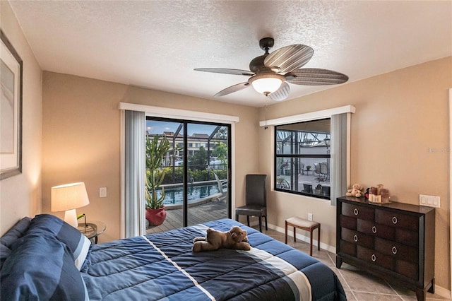 bedroom with ceiling fan, access to outside, a textured ceiling, and light tile patterned flooring