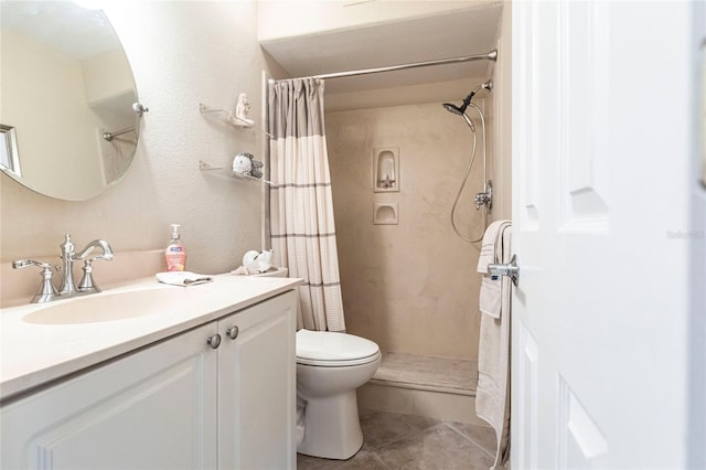 bathroom with tile patterned flooring, vanity, a shower with shower curtain, and toilet