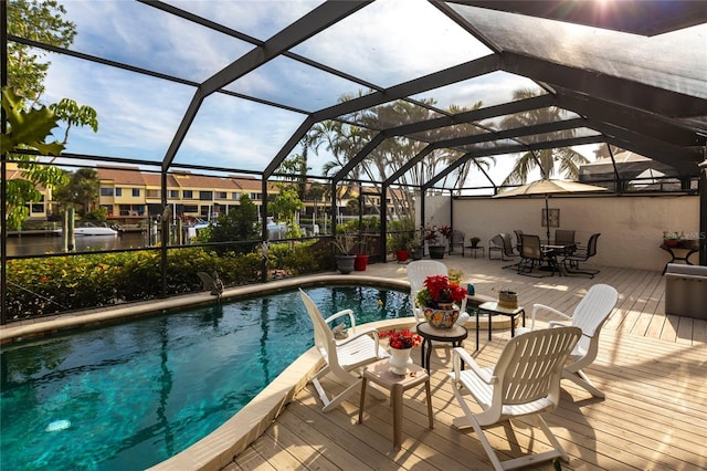 view of swimming pool featuring glass enclosure