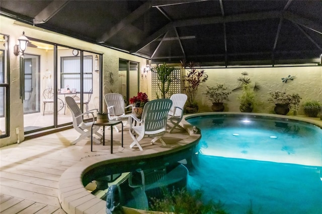 view of swimming pool featuring a lanai