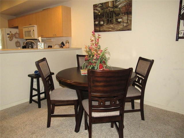 dining area with light colored carpet