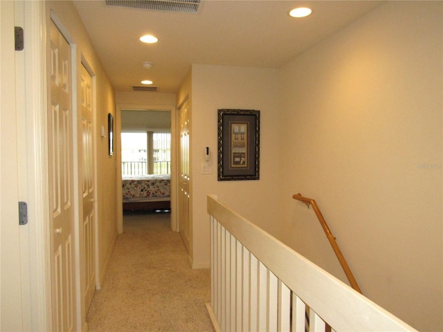 hallway with light colored carpet