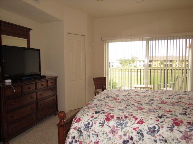 carpeted bedroom featuring a closet and access to outside