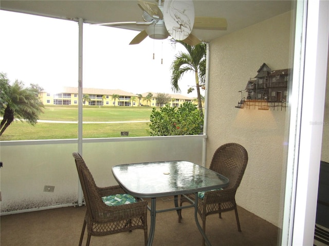 sunroom featuring ceiling fan