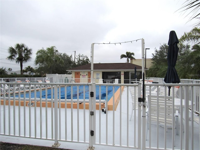 view of gate featuring a community pool