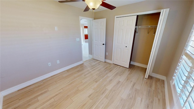 unfurnished bedroom featuring light wood-type flooring, ceiling fan, and a closet