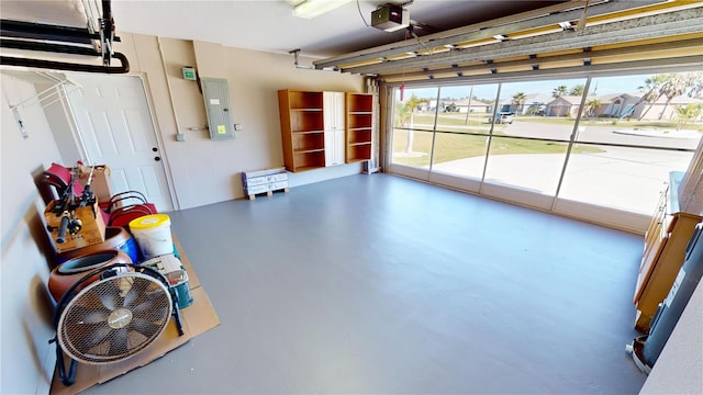 garage with a garage door opener and electric panel