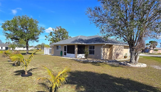 rear view of house with a yard