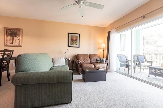 carpeted living room featuring ceiling fan