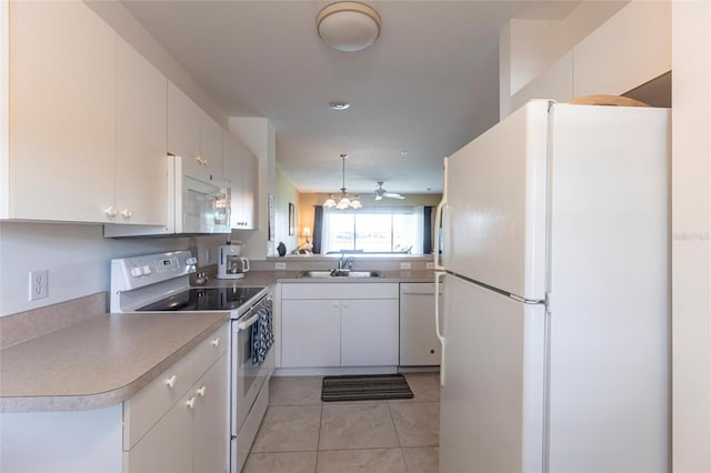 kitchen with sink, white cabinetry, light tile patterned floors, kitchen peninsula, and white appliances