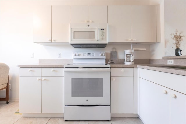 kitchen featuring white appliances and white cabinets