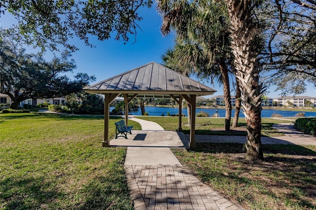 view of community with a gazebo, a lawn, and a water view