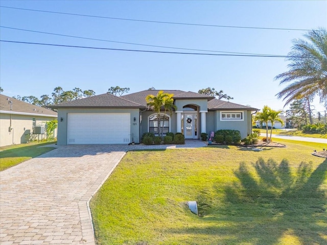 view of front of home featuring a garage and a front lawn