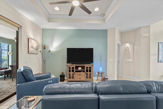 living room with crown molding, ceiling fan, and a raised ceiling