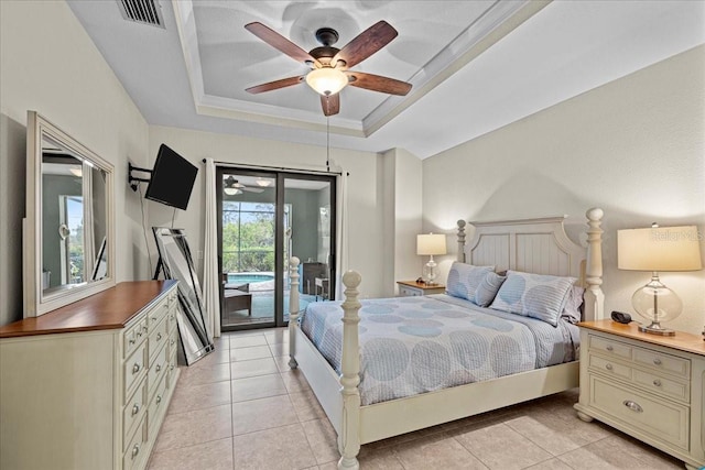 bedroom featuring ceiling fan, a tray ceiling, access to exterior, and light tile patterned floors