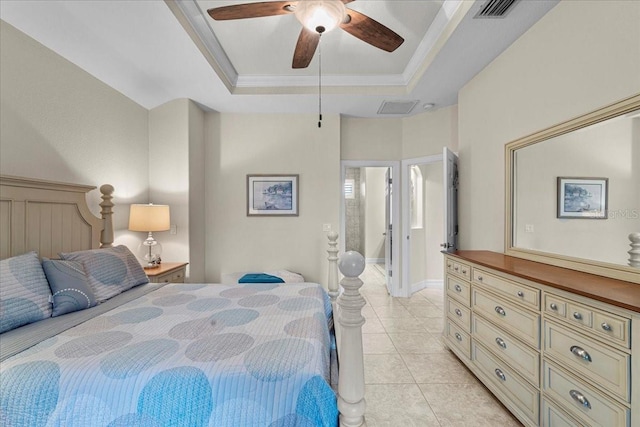 tiled bedroom with a tray ceiling, ornamental molding, and ceiling fan