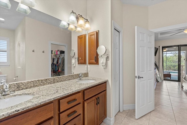 bathroom with tile patterned flooring, vanity, plenty of natural light, and toilet