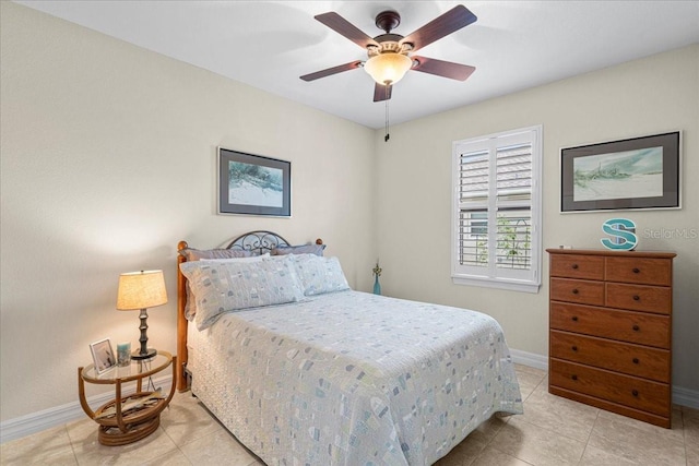 bedroom with ceiling fan and light tile patterned floors