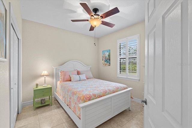 bedroom featuring light tile patterned floors and ceiling fan