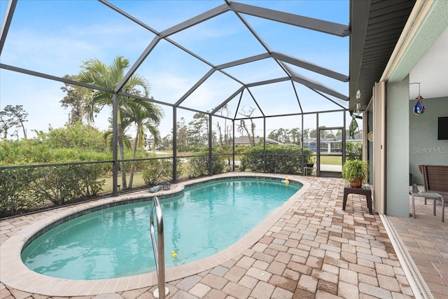 view of swimming pool featuring a lanai and a patio area