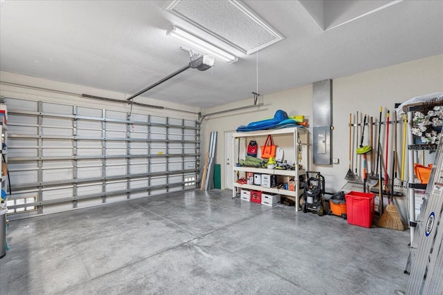 garage with a garage door opener and electric panel