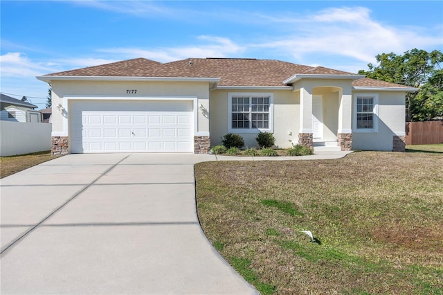 view of front of house featuring a garage and a front yard