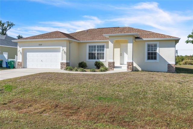 view of front of home with a garage and a front yard