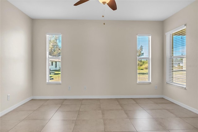 spare room featuring light tile patterned floors and ceiling fan