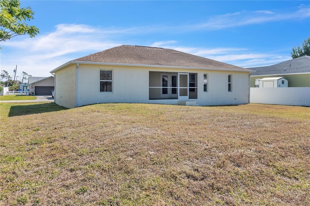 rear view of house with a lawn