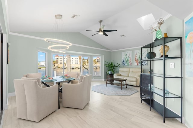 dining space with ceiling fan with notable chandelier and vaulted ceiling