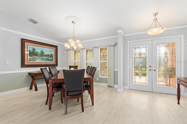 dining room featuring crown molding, lofted ceiling, a notable chandelier, and french doors