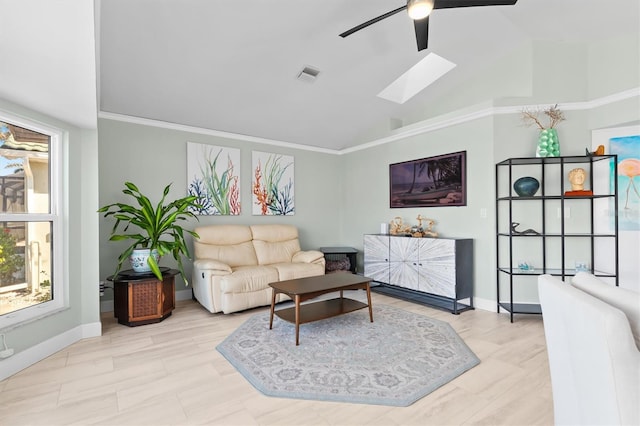 living room with ceiling fan, a skylight, and a wealth of natural light