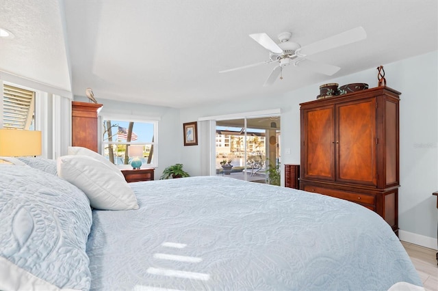 bedroom with access to exterior, ceiling fan, and light hardwood / wood-style flooring