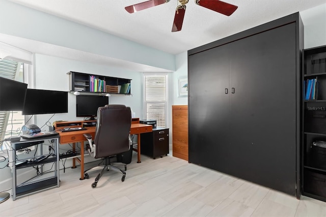 office space with ceiling fan and a textured ceiling