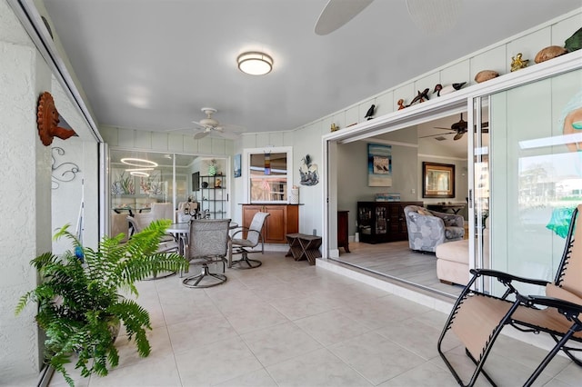 sunroom featuring ceiling fan