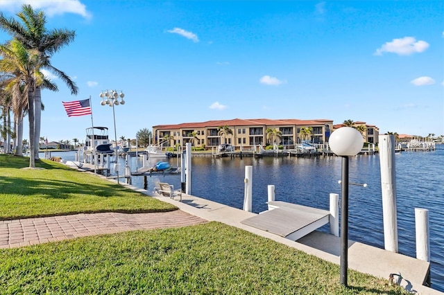 dock area with a water view and a yard