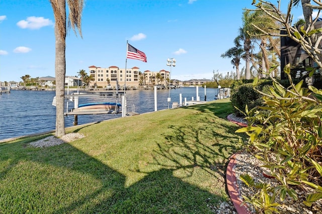 view of dock featuring a water view and a lawn