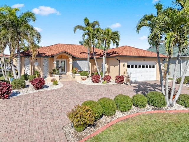 mediterranean / spanish home featuring a garage